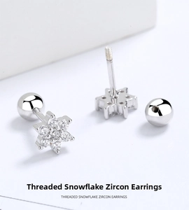 Macro detail of silver snowflake zircon stud earrings with secure threaded screw backs