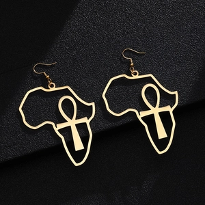 Detailed view of gold African map earrings with Ankh symbol on black textured surface