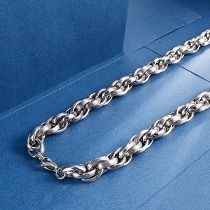 Close-up of silver stainless steel curb chain with lobster clasp and detailed metal texture