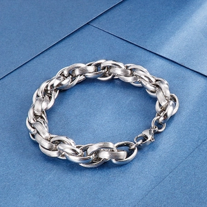 Close-up of silver stainless steel curb chain bracelet with lobster clasp and mixed texture