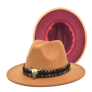 Detail of wool fedora hat with bull head buckle and ethnic woven band on the brim