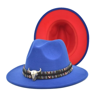 Detail of blue wool fedora featuring a tribal band and silver bull skull ornament