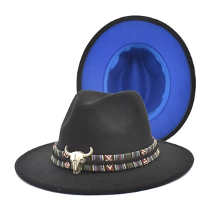 Detail of western fedora hat featuring a bull head metal ornament and blue brim lining
