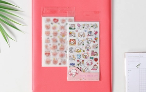 Detail showing colorful cartoon washi stickers on a folder with various cute dog patterns