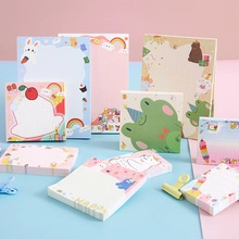 Detailed flat lay of colorful cartoon memo pads featuring rabbit and dessert patterns