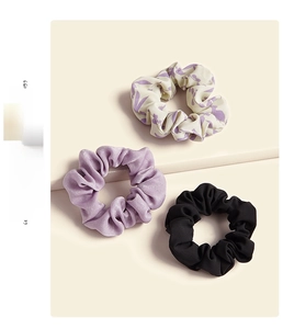 Detailed set of satin scrunchies in purple floral, lavender, and classic black tones