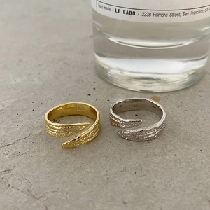 Detail of S925 sterling silver rings with gold and silver leaf texture and hallmarked stamp