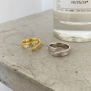 Close-up of S925 sterling silver rings with hammered gold and silver foil texture