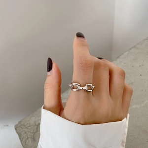 Detailed view of 925 sterling silver chain ring on finger with elegant contrast