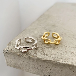 Detailed macro view of S925 sterling silver stamp on minimalist chain texture rings
