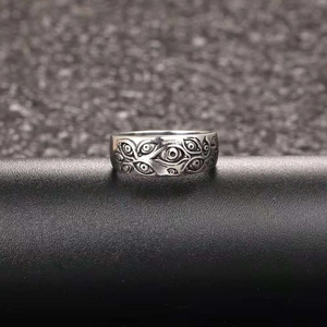 Macro shot of gothic silver ring featuring intricate embossed evil eye relief patterns