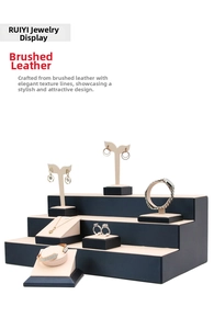 Detail of multi-tier navy blue brushed PU leather jewelry display stand set with beige pads