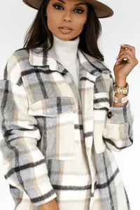 Detail of plaid shacket featuring large check pattern and front chest flap pockets