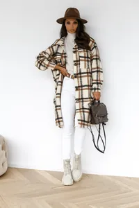 Detail of checkered plaid shacket with front button closure and flap chest pockets