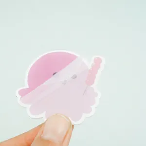 Cute cartoon acrylic keychain in soft pink with protective film being peeled off