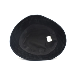 Detail view of the black bucket hat featuring diamond quilted lining and wash care label