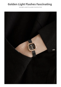 Detail of rose gold square watch with black dial and mesh strap on female wrist