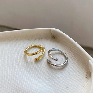 Detailed macro view of S925 sterling silver stamp on minimalist wave rings