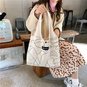 Detail of minimalist canvas tote bag with abstract line art and snap button closure