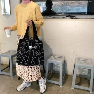 Artistic black canvas tote bag with white abstract lines and spacious interior