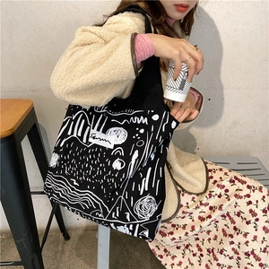 Lifestyle shot of high-capacity canvas tote bag with abstract print and hand straps