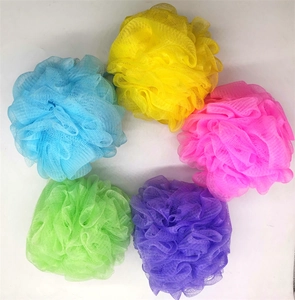 Macro detail of multi-color bath sponges showing fine mesh texture and vibrant fiber