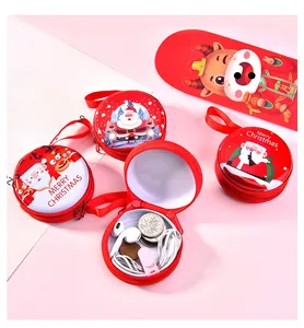 Macro detail of round red Christmas tin pouches with Santa and reindeer illustrations