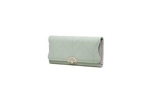 Detail view of leaf quilted pattern on light green faux leather long wallet with gold buckle