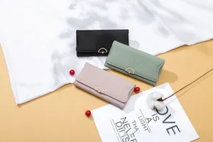 Detailed view of three long tri-fold PU leather wallets with leaf vein embossing and buckle