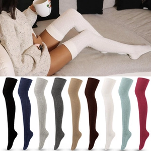 Thigh-high knitted thermal socks shown in various colors and worn in a cozy home setting