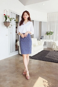 Detail of high waist blue polka dot pencil skirt paired with a white collared shirt