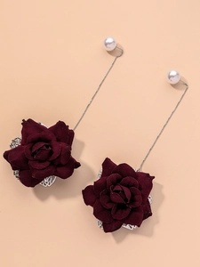 Detail of burgundy floral drop earrings with white pearl studs and silver chains
