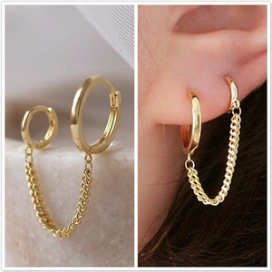 Detailed view of double hoop earrings with a long chain link in a golden finish