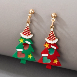 Macro detail of Christmas tree earrings with red and green enamel and striped star caps