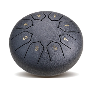 Close-up of a 8-note steel tongue drum in textured dark grey with golden numbers