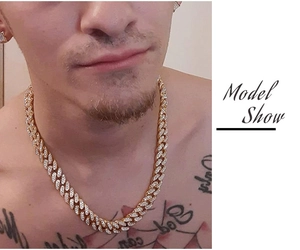 Close-up of golden hip hop Cuban link necklace with iced-out rhinestones on model neck