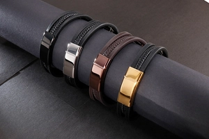 Detail showing braided leather bracelets with multi-color metallic magnetic clasps on a prop