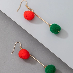 Detail of festive Christmas earrings featuring red and green pom poms on gold metal rods