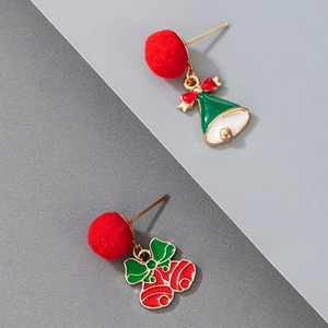 Detail shot of Christmas pompom earrings with festive green and red bells on gray background