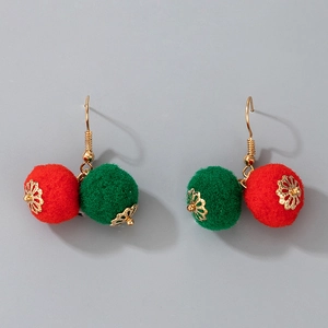 Detailed view of festive Christmas earrings featuring red and green plush pom-pom drops