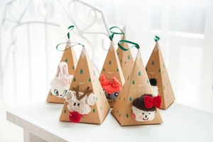 Festive Christmas gift box with reindeer coral fleece socks and green ribbon handle