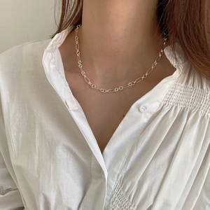 Close-up of minimalist 925 sterling silver circle choker necklace worn on neck