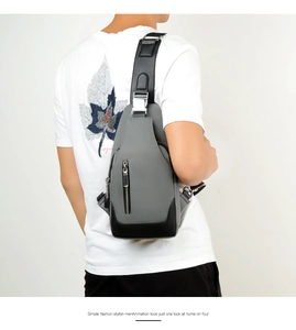 Detail of grey crossbody sling bag for men with metal adjustment buckle on the strap