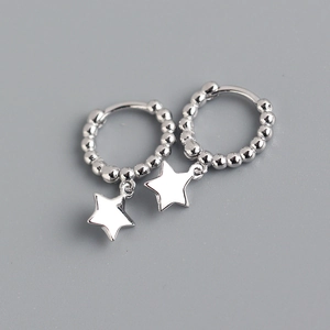 Macro shot of S925 sterling silver hoop earrings with polished round beads and star charms