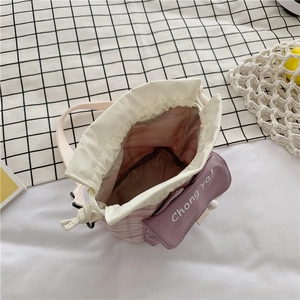 Internal view showing storage space and drawstring closure of pink canvas bucket bag
