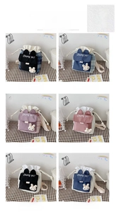 Close-up of cute cartoon canvas bucket bags with bunny ears and drawstring details