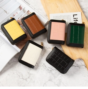 Detailed view of crocodile pattern card holders in six vibrant colors with gold zippers