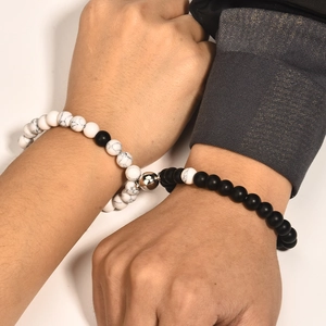 Magnetic couple bracelets with white marble and matte black beads on wrist