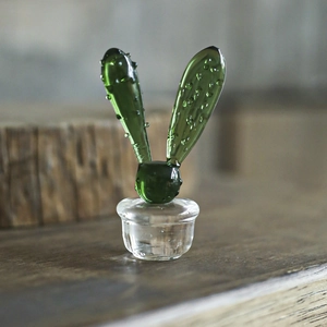 Handmade green glass cactus ornament with realistic water droplets on transparent base