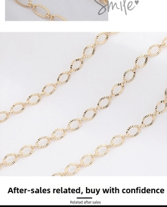 Detailed macro view of gold-plated flat oval chain links with fine embossed texture
